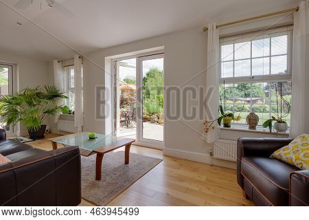 Stradishall, Suffolk, England - June 1 2017 Furnished Modern Garden Living Room With Open Patio Door
