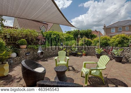 Stradishall, Suffolk, England - June 1 2017 Garden Patio Area  With Rattan Furniture And Sunshade