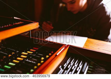 Girl Teenager Artist Sits And Draws. Toned Image, Real Life, Blurred Background, Soft Focus