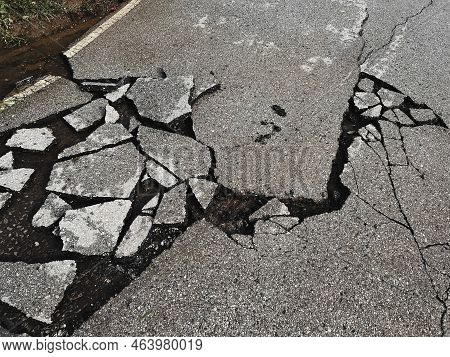 Decayed Road Paved Asphalt Distressed Road Surface With Damaged, Peeling Damaged Road Waiting For Ro