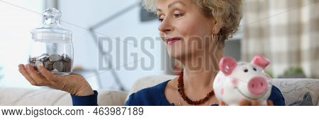 Portrait Elderly Female Hold Glass Container With Saved Money For Retirement And Piggybank. Financia