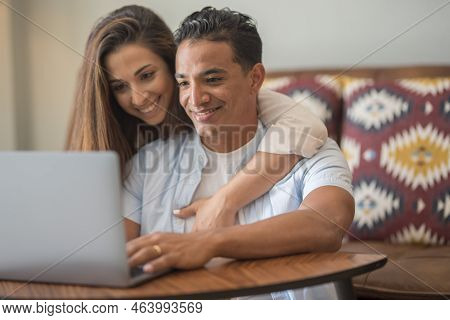 Young Happy Couple At Home Boy And Girl Surfing The Web Together Smiling And Enjoying Internet Searc