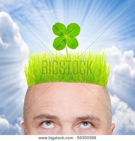 Funny picture of a irish man with four leaf clover on green hair. St. Patrick day concept.
