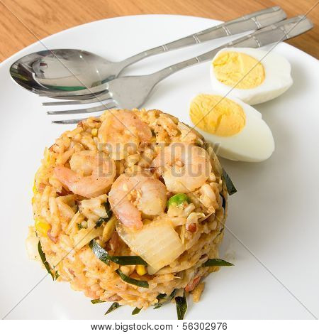 Khow Pat Tom Yum Koong - Stir fried spicy rice with herbs and prawns serving with boiled egg thai fo