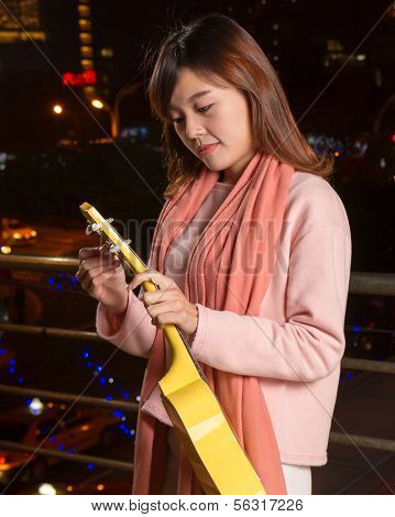 Pretty Asian Woman With Ukelele