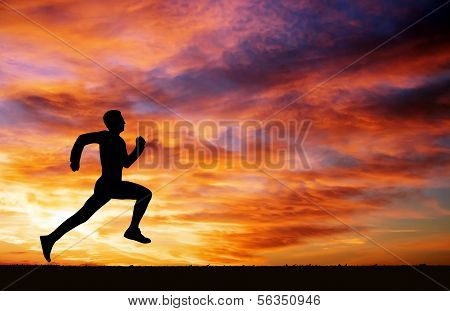 Silhouette Of Running Man On Sunset Fiery Background