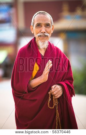 KATHMANDU, NEPAL - DEC 6: Portrait of unidentified monk circle Boudhanath, Dec 6, 2013 in Kathmandu, Nepal. Stupa is one of the largest in the world, of 1979 is a UNESCO World Heritage Site.