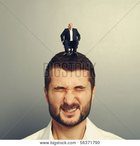 portrait of emotional man with small happy boss on the head