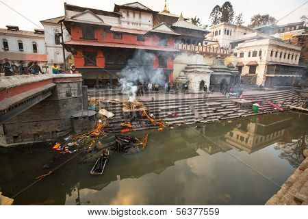 KATHMANDU, NEPAL - DEC 20: During the cremation ceremony along the holy Bagmati River in Bhasmeshvar Ghat at Pashupatinath temple, Dec 20, 2013 in Kathmandu, Nepal.