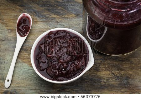 sugar free cranberry sauce with addition of blueberry, apples and honey - small bowl, jar and spoon