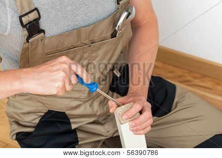 Handyman Repairing Table Leg