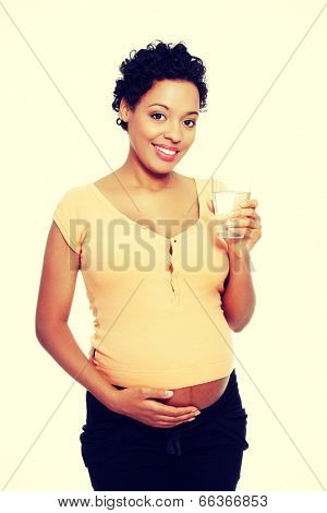 Pregnant woman with glass of water.