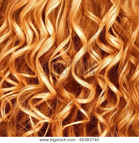 Curly Red hair closeup. Wavy blond hair background. Close up texture of long permed hair. Hairstyle