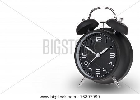 Black Alarm Clock With The Hands At 10 And 2
