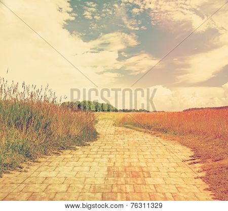 yellow brick road through green meadows, fantasy background, retro filtered, instagram style