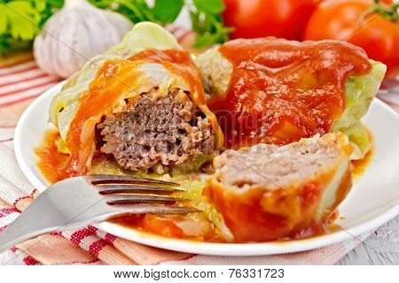Cabbage stuffed with tomato sauce on light board