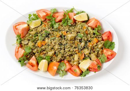Traditional Egyptian freek vegetable pilaf, with the roasted wheat grain taking the place of rice, as freekeh (or frikeh) is cooked in stock with chopped veg, seen from above.