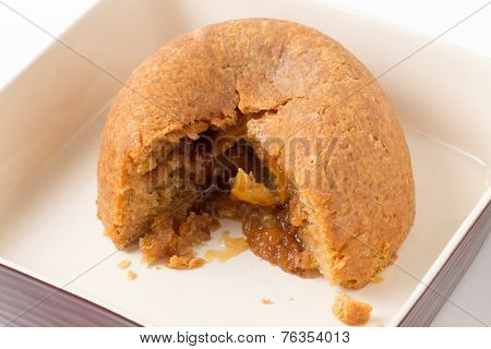 Sussex pond pudding, a steamed British dish filled with a lemon encased in sugar and butter.