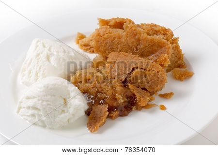 Sussex pond pudding, a steamed British dish filled with a lemon sugar and butter and served with ice cream.