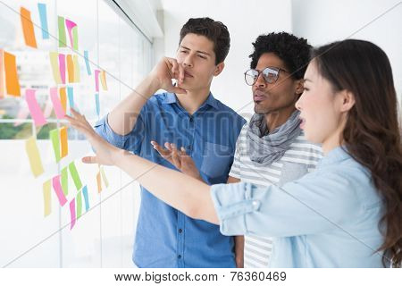 Young creative team brainstorming together in creative office