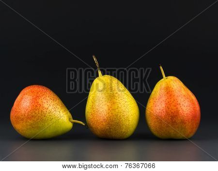 Three Pears Against Dark Background