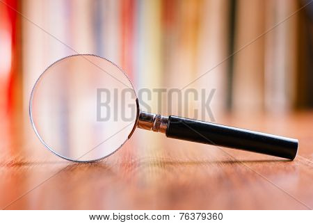Close Up Magnifying Glass Leaning On Wooden Table