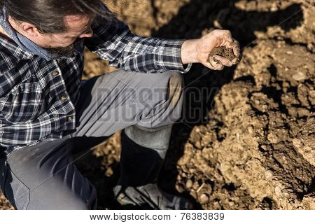 Close Up From A Farmer With Soil In His Hand