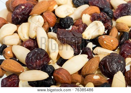 mixed nuts and dried fruits isolated on white background