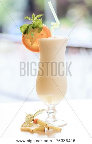 Milk cocktail with orange and carom
