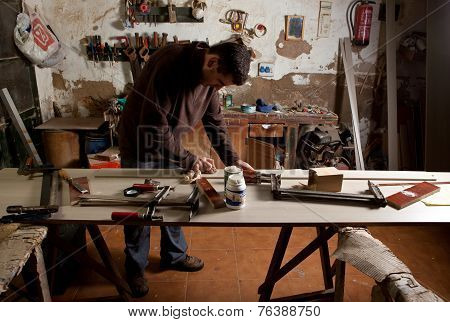 Carpenter Cleaning The Glue