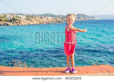 Adorable little girl at tropical beach on summer italian vacation