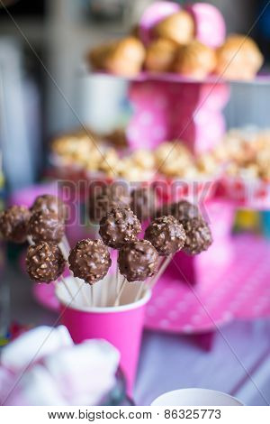 Chocolate cakepops on holiday dessert table at kid birthday party