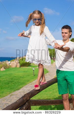 Adorable little girl and happy dad outdoor