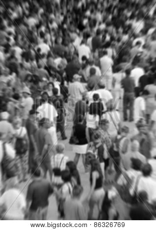 Blurred background showing a crowd in black and white