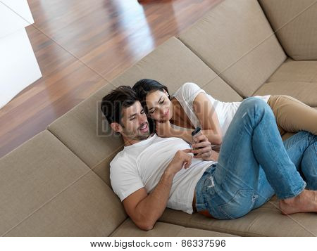 cheerful happy young couple making selfie together at home