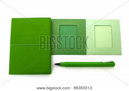 Green Notebook And Pen Isolated Over White