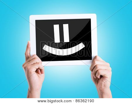 Tablet pc with text Smiley Face with blue background