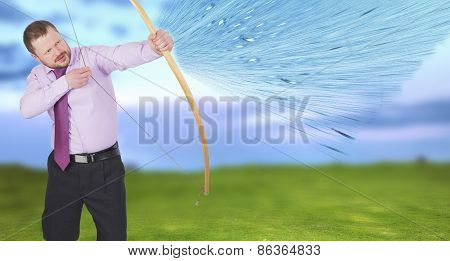 Businessman practicing archery with green field in background