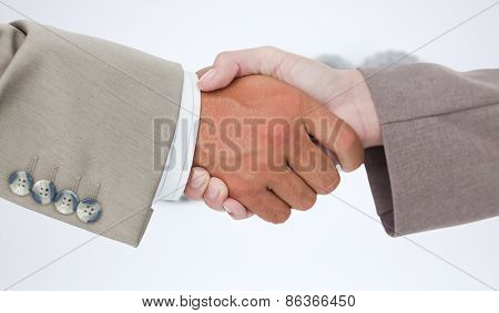 Side view of business peoples hands shaking against cogs and wheels