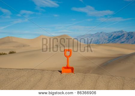 Plastic Shovel In A Sand Dune