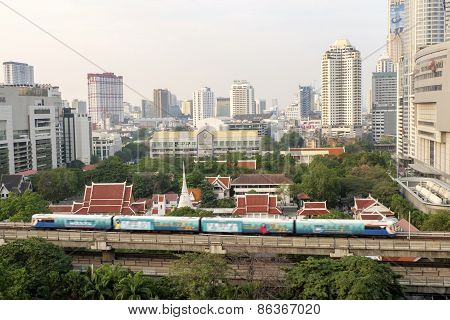 Bangkok,thailand-february 17:bangkok Mass Transit System (bts) Pass The Pathumwanaram Temple At Siam