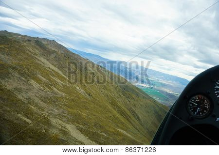 Aerial photo taken flying between the converging hills of the Southern Alps