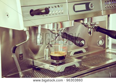 Prepares espresso in coffee shop ( Filtered image processed vintage effect. )