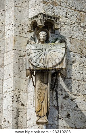 Statue Of Angel Holding Sundial At Cathedral Our Lady Of Chartres, France