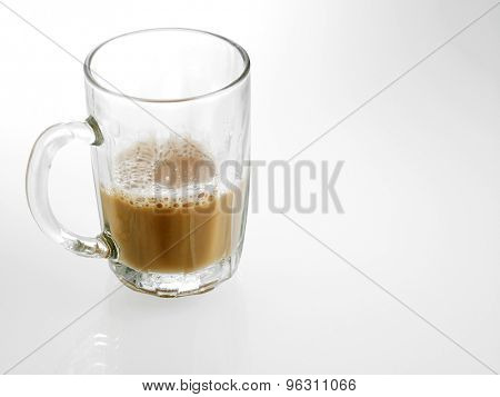 Half glass of Tea with milk or Teh Tarik in Malaysia