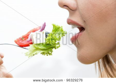 Woman eating healthy food, Greek salad
