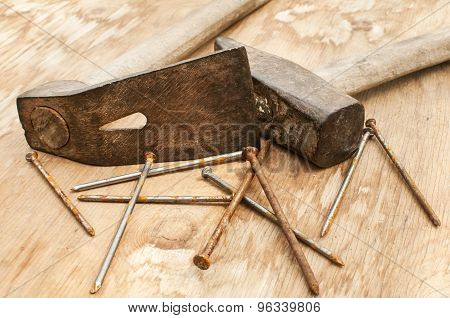 Old hammer, adze and rusty nails