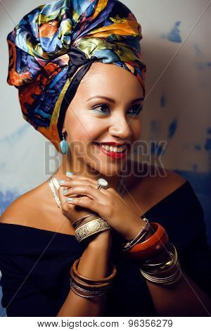 beauty bright african woman with creative make up, shawl on head like cubian