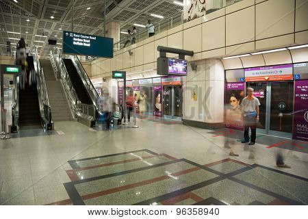 SINGAPORE - CIRCA FEBRUARY, 2015: Passengers at the MRT station in Singapore. MRT is a rapid transit system forming the major component of the railway system in Singapore.