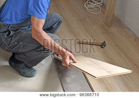 Male Carpenter Puts The Laminate